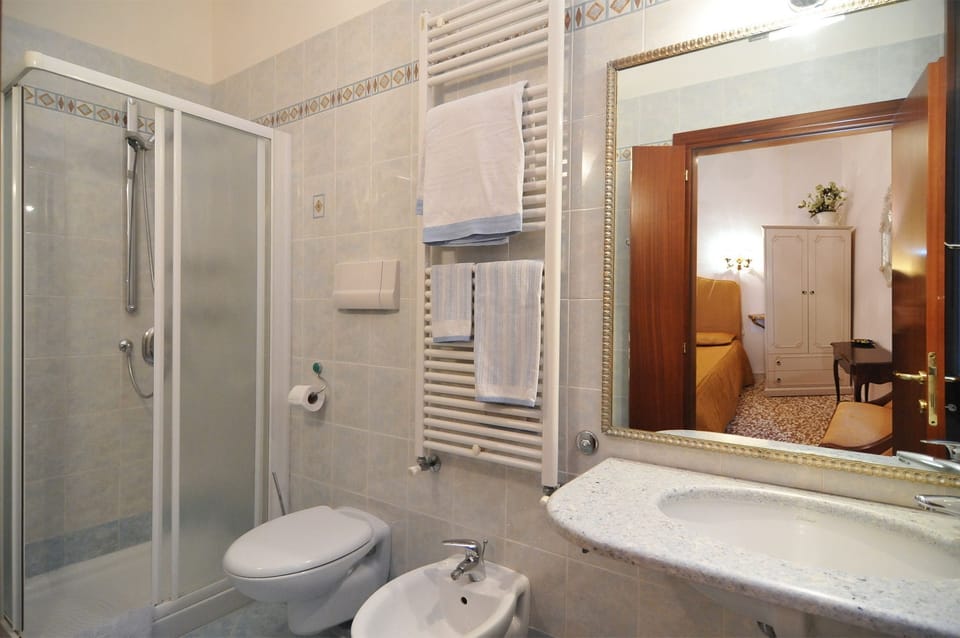 Bathroom | Shower, rainfall showerhead, hair dryer, towels