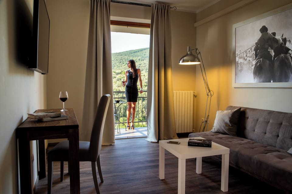 Suite, Balcony, Hill View | Living area | Flat-screen TV