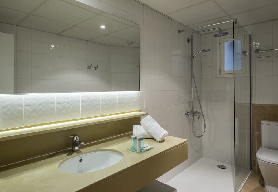 Shower, eco-friendly toiletries, hair dryer, towels