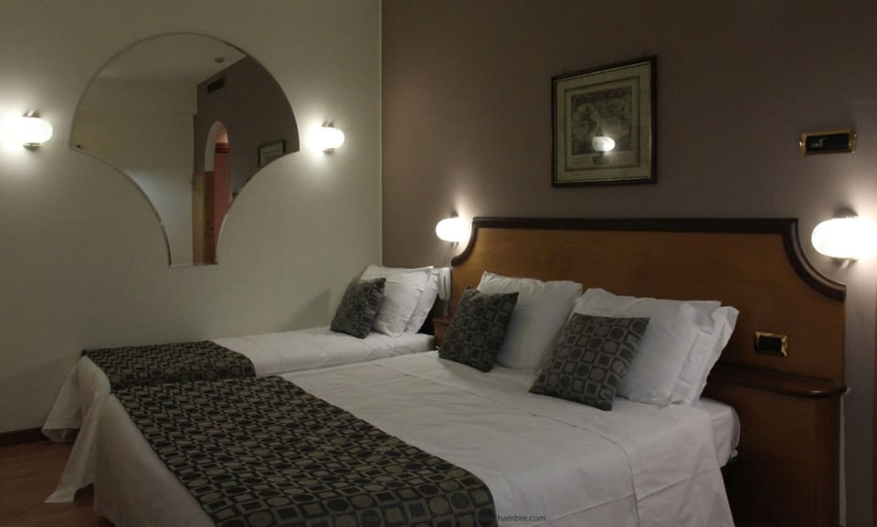 Classic Triple Room | Minibar, in-room safe, desk, blackout drapes