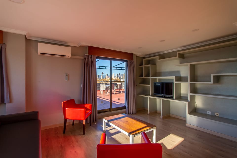 Standard Penthouse | Living area | Flat-screen TV, books