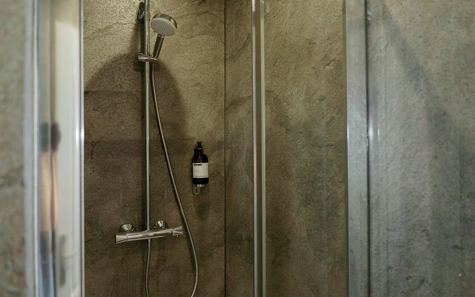 Shower, rainfall showerhead, hair dryer, towels