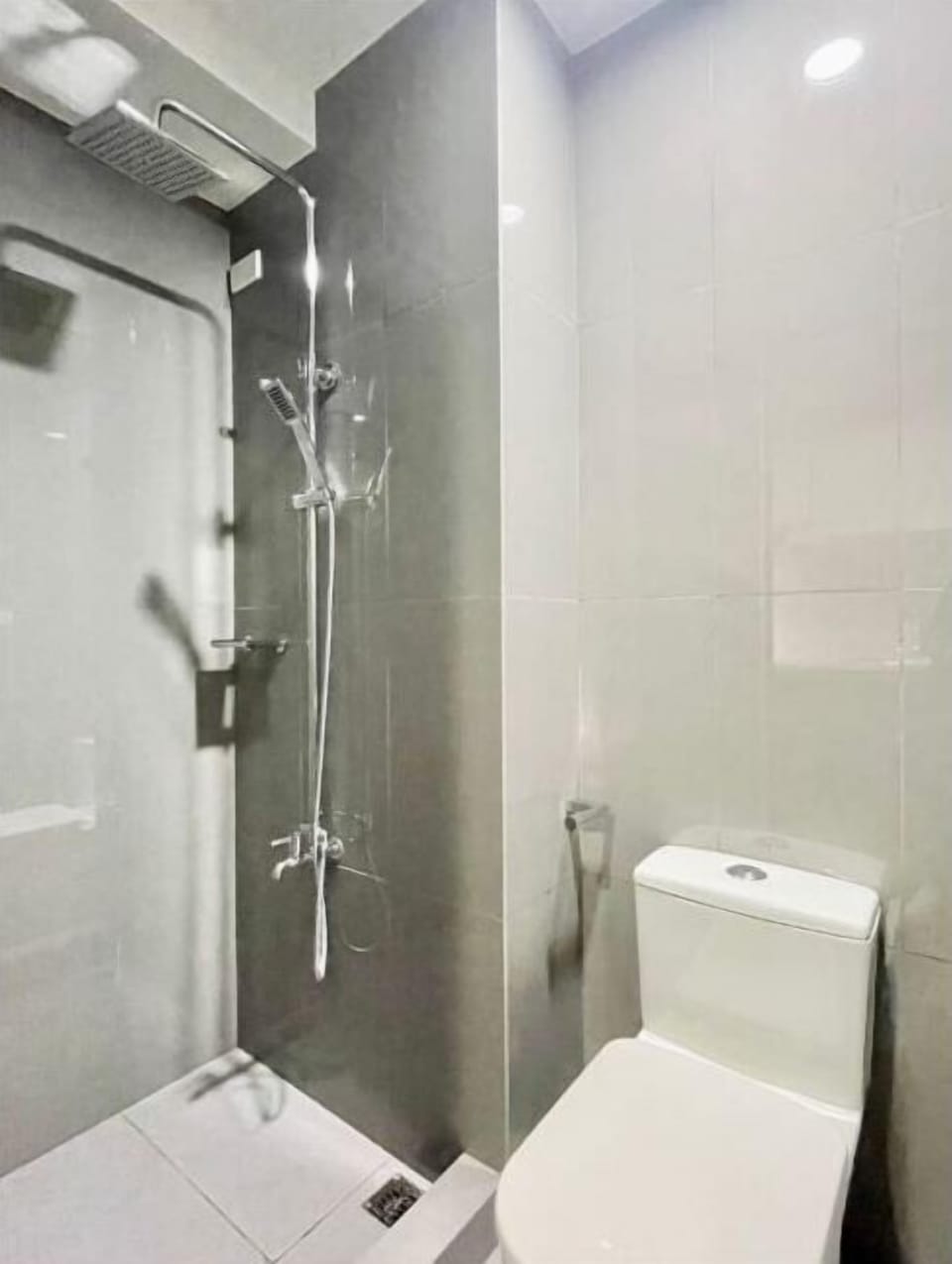 Shower, hair dryer, slippers, towels