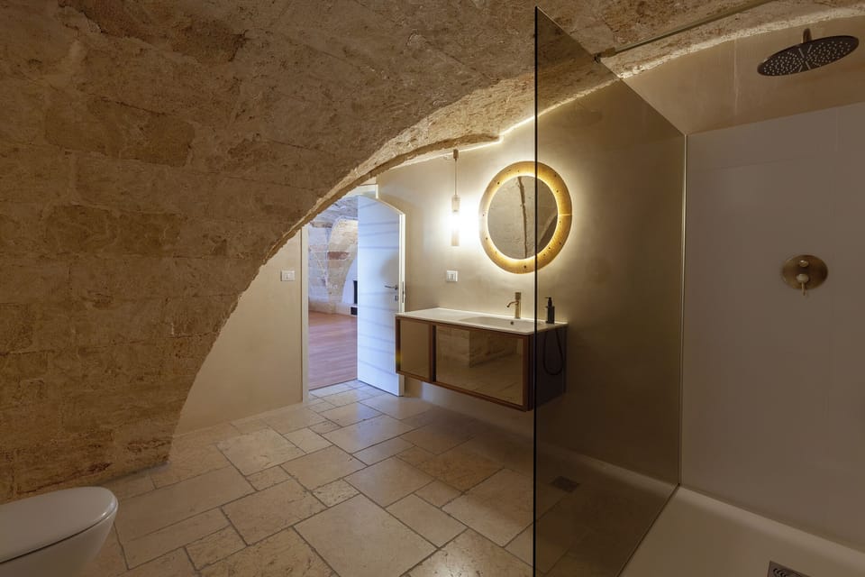Luxury Suite (Baia delle Zagare) | Bathroom | Hydromassage showerhead, hair dryer, bathrobes, slippers