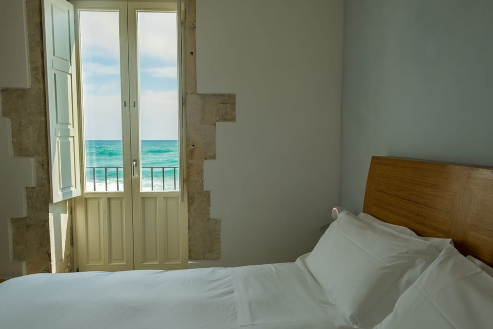 Double Room, Sea View | Minibar, in-room safe, desk, iron/ironing board