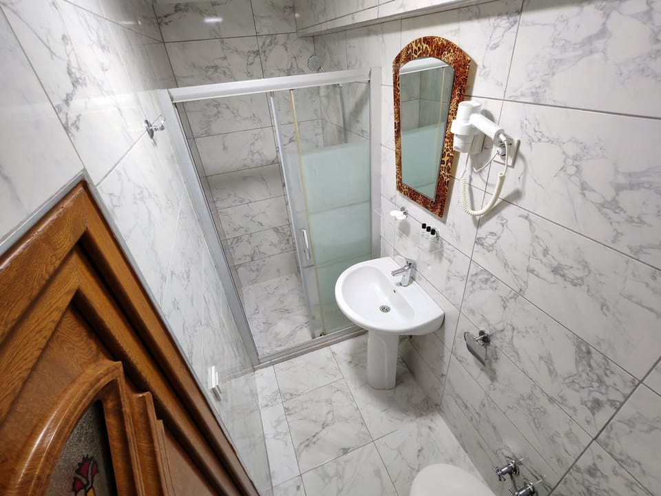 Shower, hair dryer, slippers, towels