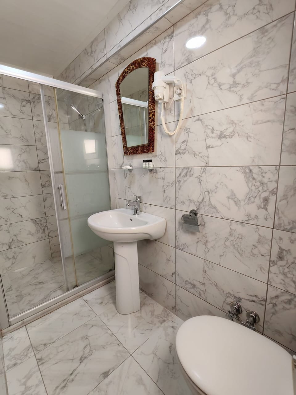 Shower, hair dryer, slippers, towels
