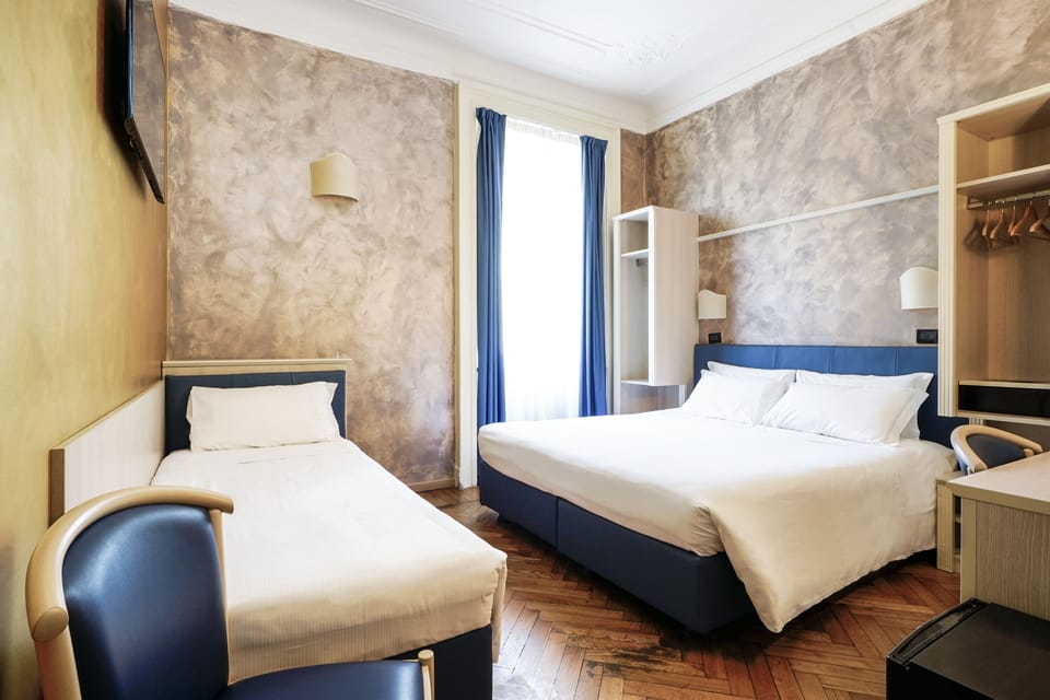 Triple Room | Down comforters, minibar, in-room safe, individually decorated