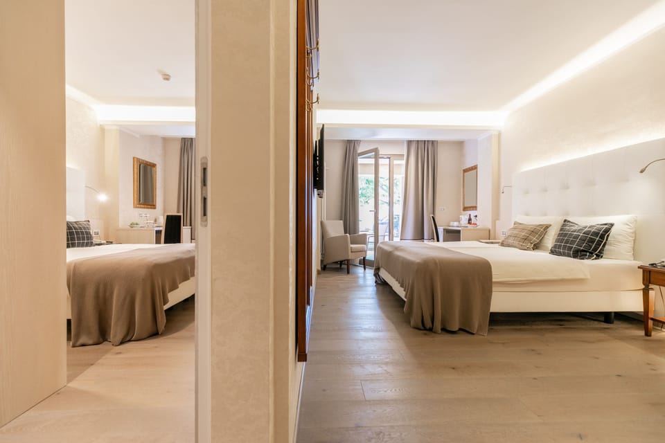 Family Room | Minibar, in-room safe, individually furnished, desk