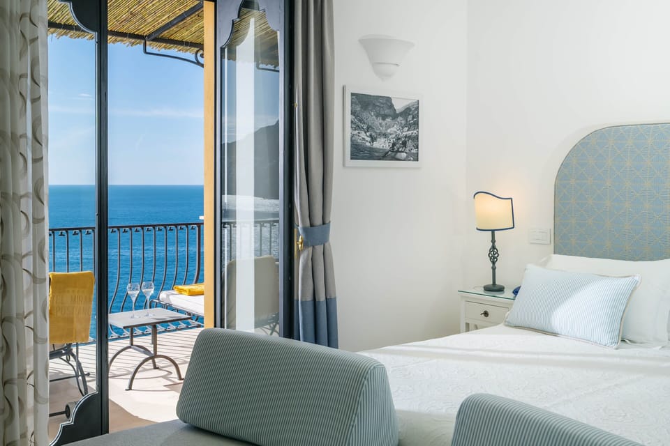 Junior Suite, Balcony, Sea View | Premium bedding, minibar, in-room safe, individually decorated