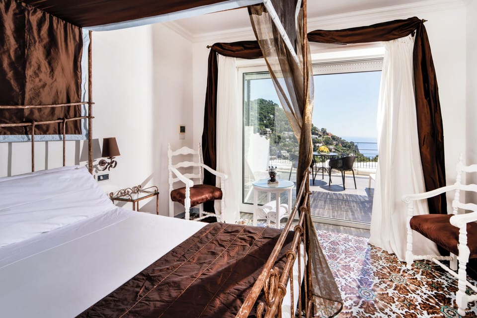 Deluxe Room, Sea View | Minibar, in-room safe, desk, laptop workspace