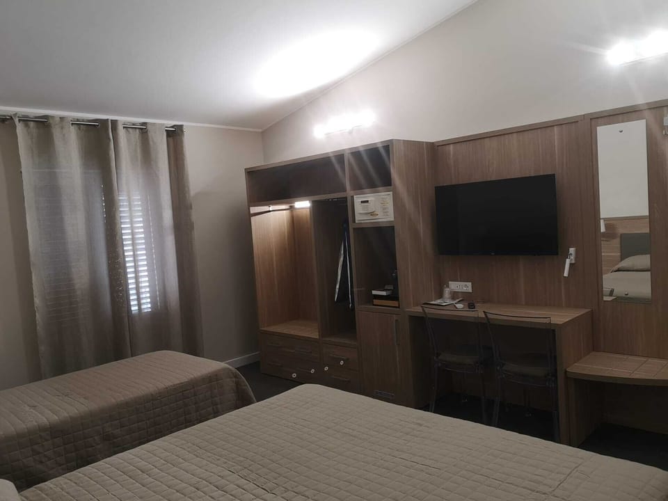 Triple Room | Minibar, in-room safe, individually decorated, desk