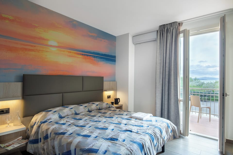Superior Quadruple Room | Minibar, in-room safe, desk, laptop workspace