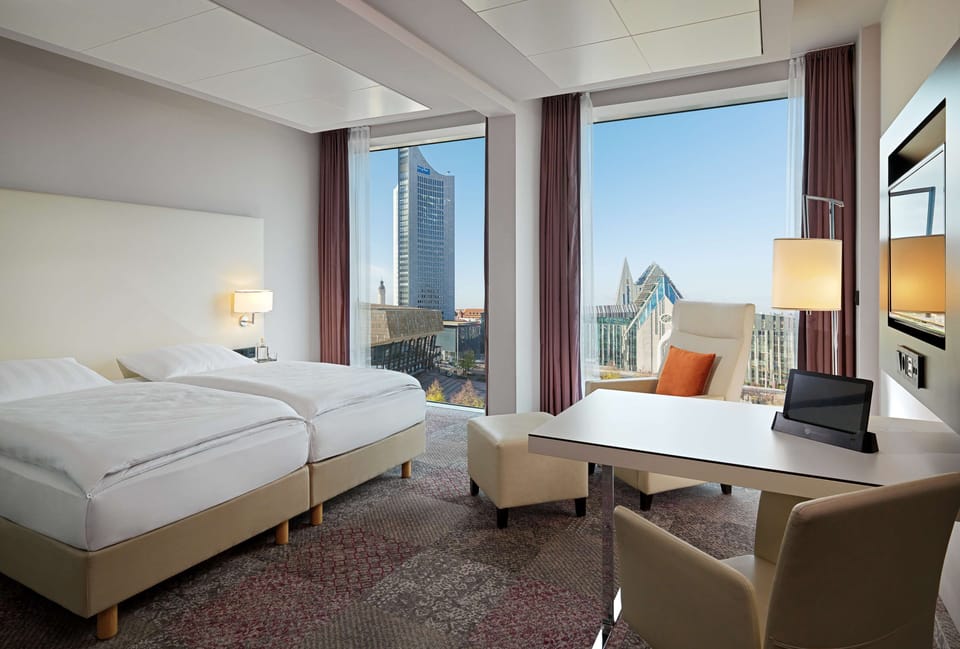 Premium Room (upper floors, Augustusplatz View) | In-room safe, desk, laptop workspace, soundproofing