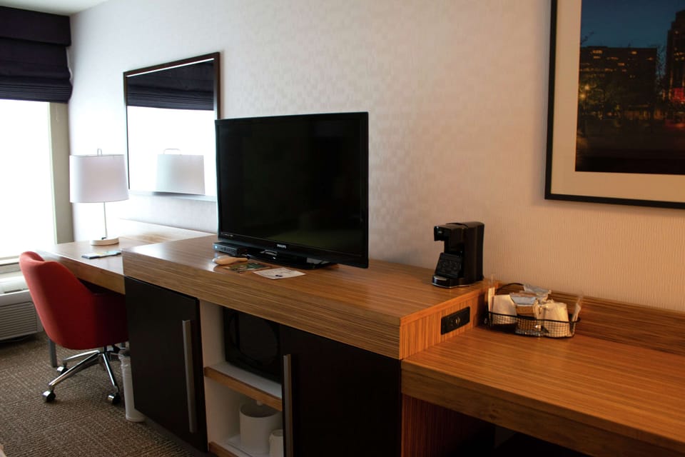 Premium bedding, desk, laptop workspace, blackout drapes