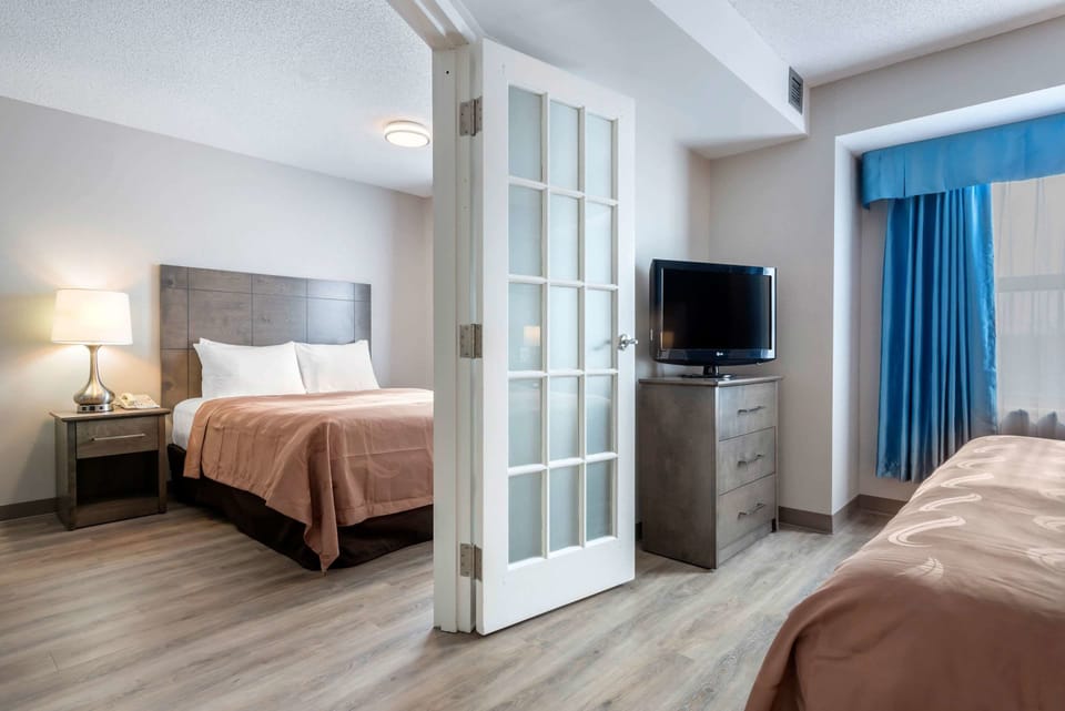 Suite, 1 King Bed and 1 Queen Bed, Non Smoking | Premium bedding, desk, laptop workspace, iron/ironing board