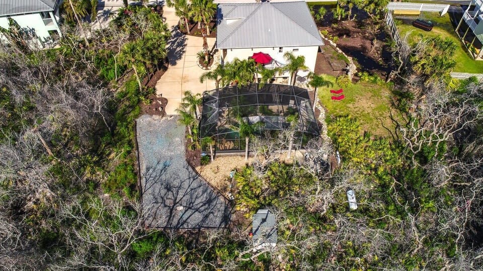 Drone view of the house, pool and yard 