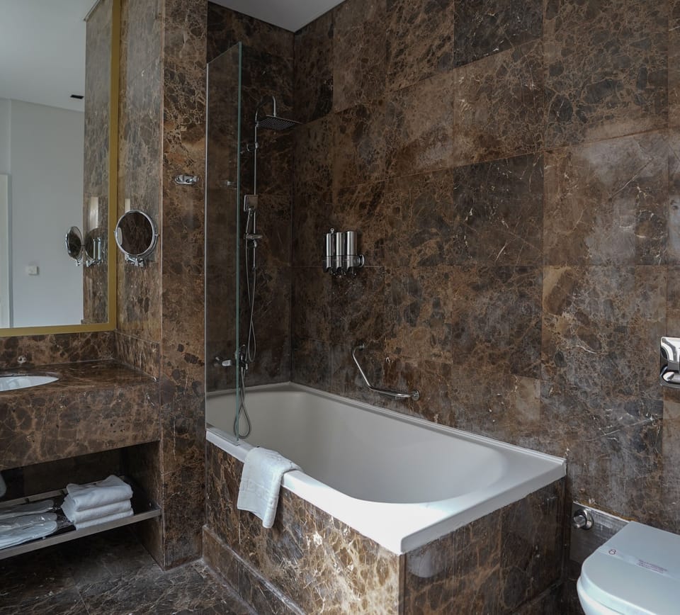 Designer toiletries, hair dryer, bathrobes, slippers