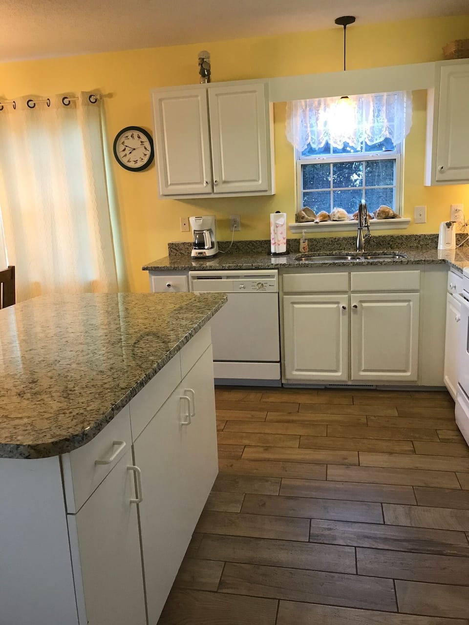Kitchen with wood look tile and granite countertops