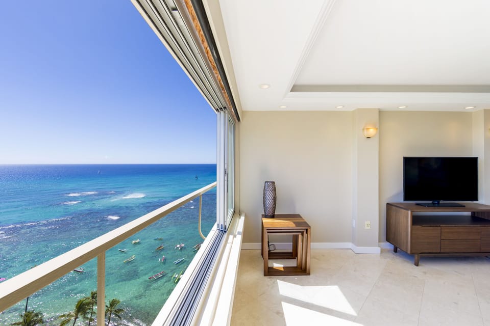Living Room - View of the living area and out towards you ocean and swaying palm trees below.