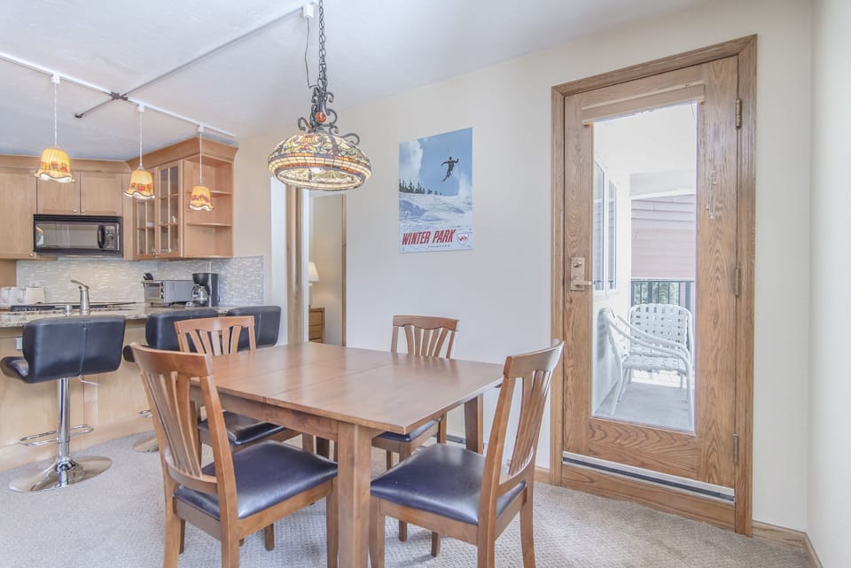 Dining Area- - Dining table with seating for four guests as well as access to the private balcony.