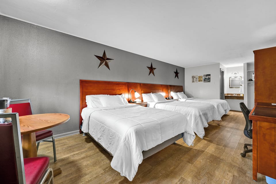 Triple Room, Non Smoking | Desk, laptop workspace, blackout drapes, iron/ironing board