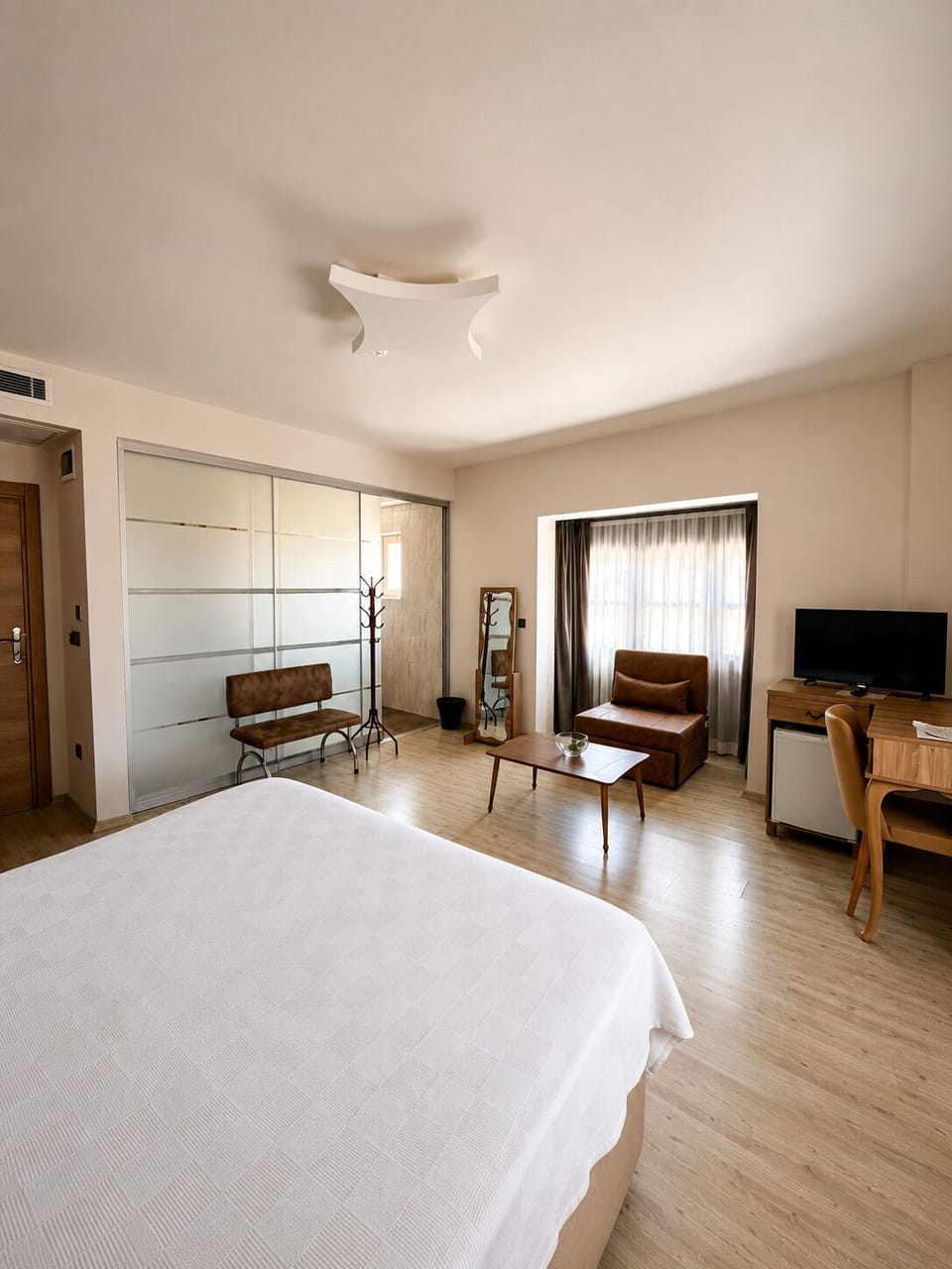 Premium bedding, desk, laptop workspace, blackout drapes