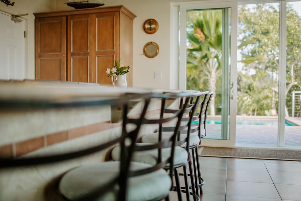 Island bar & 12' slider viewing pool & garden with plenty of natural lighting