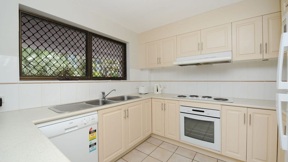 Kitchen with dishwasher, oven, cooktop, microwave and refrigerator
