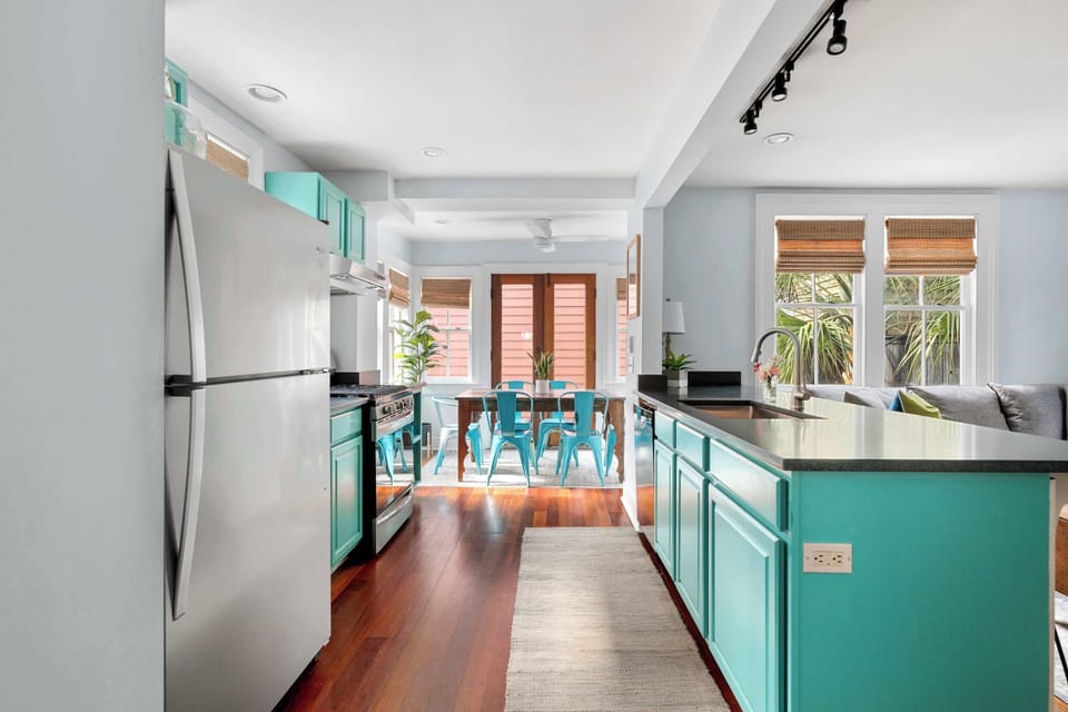 View of the kitchen island, dining and living room