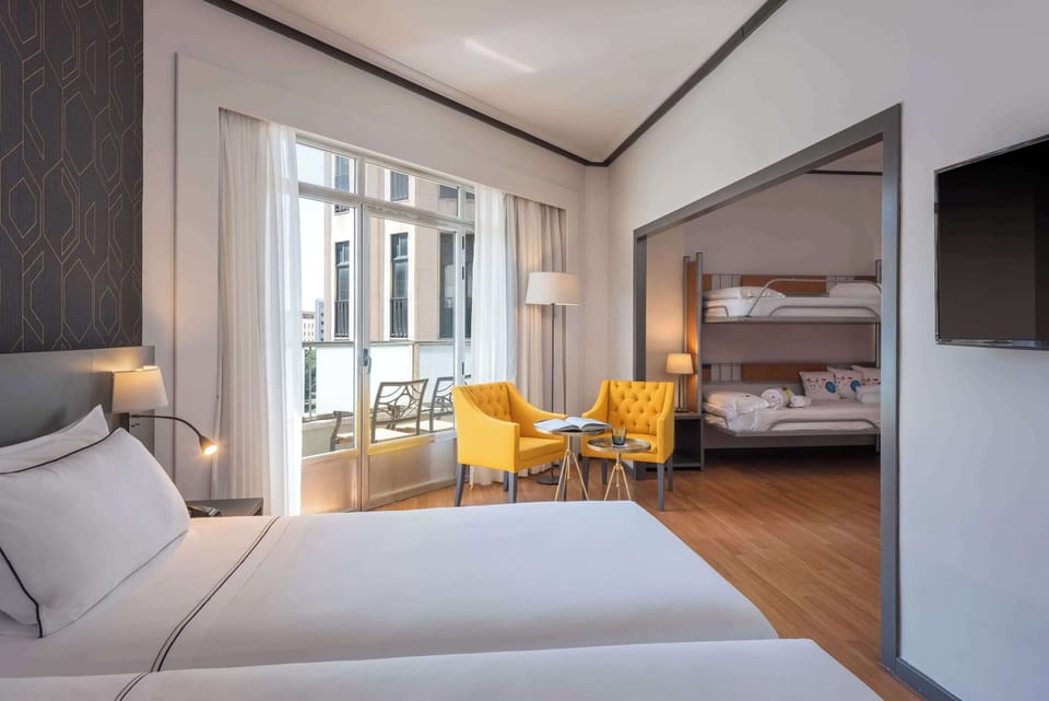 Family Room | Minibar, in-room safe, desk, blackout drapes