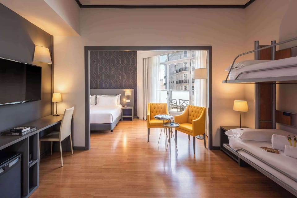 Family Room | Minibar, in-room safe, desk, blackout drapes