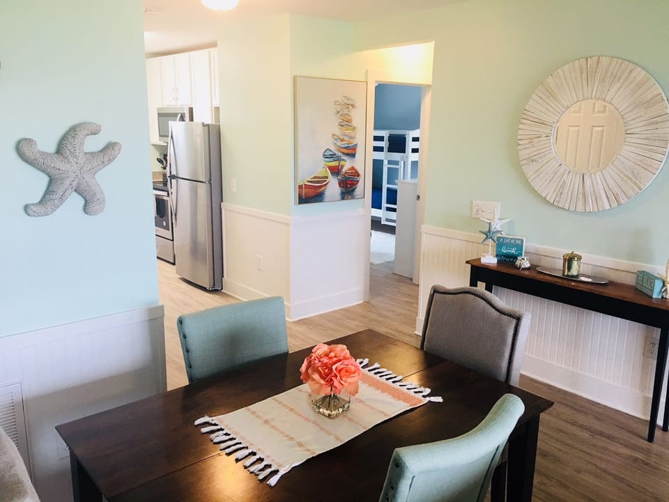 Dining area view to the kitchen and guest bedroom. Table expands to seat 8.