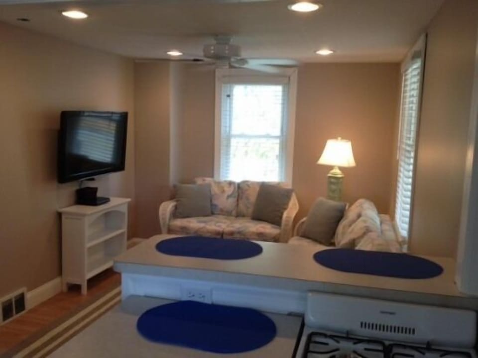 Living room with few of breakfast bar and partial kitchen area