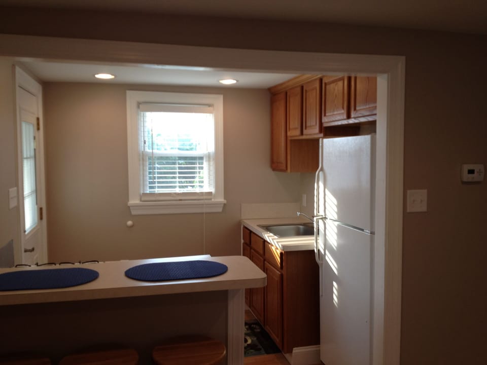 Kitchen with view of full-size refrigerator and sink area