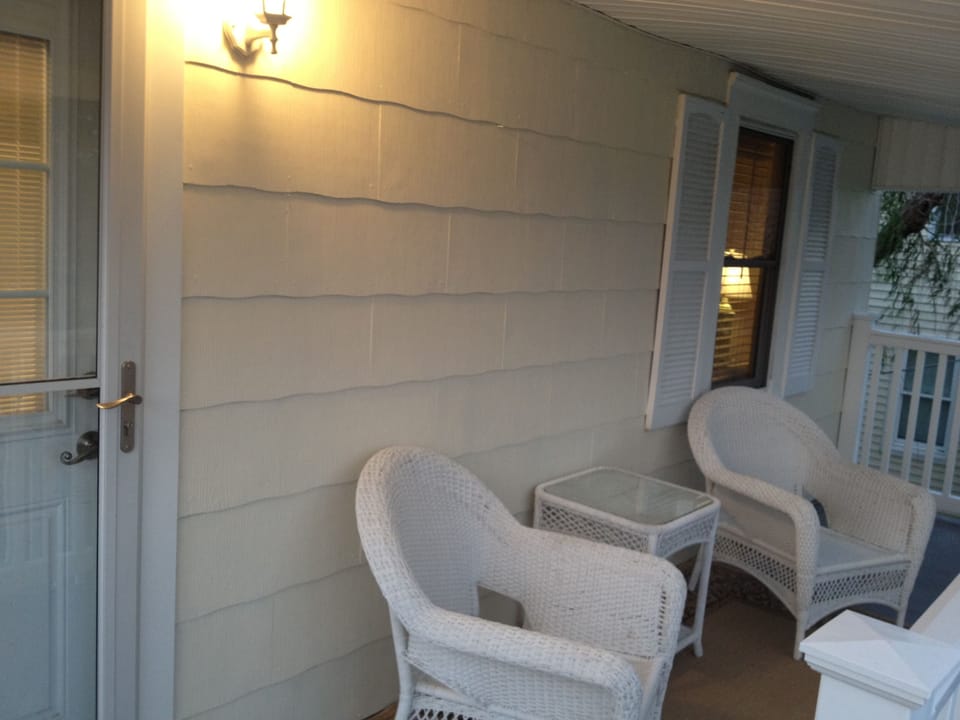 Cottage covered front porch, new furniture installed in 2023