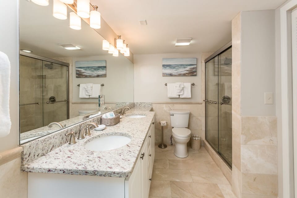  Master bath featuring marble walk in shower 