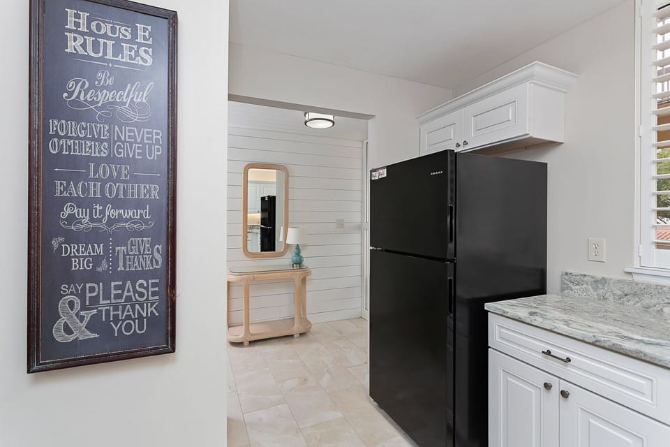 Kitchen, marble flooring, ship lap wooded foyer 