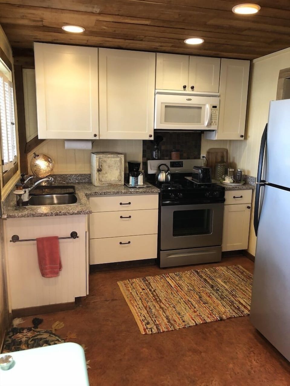 Well stocked kitchen, gas range, microwave, stainless steel fridge with icemaker