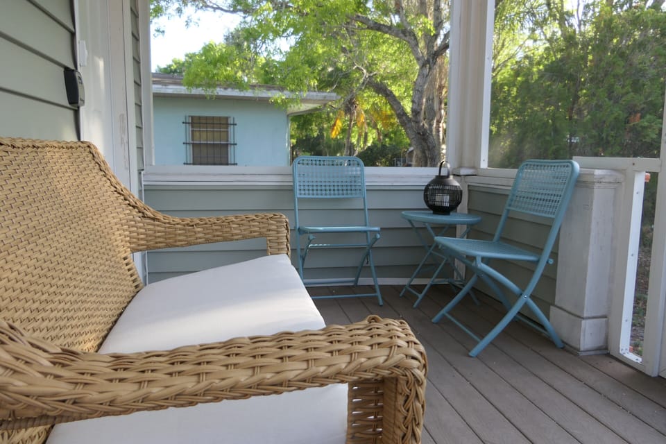 screened seating area in front of the house
