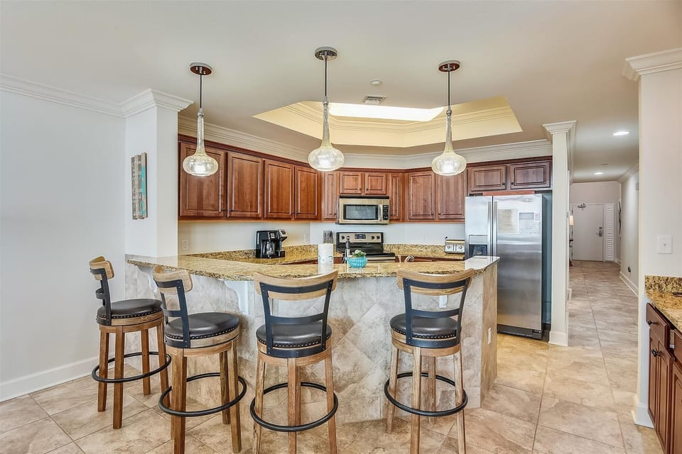 The Fully Equipped, Spacious Kitchen has Stainless Steel Appliances and Granite Counter Tops. Breakfast Bar offers seating for 4.
