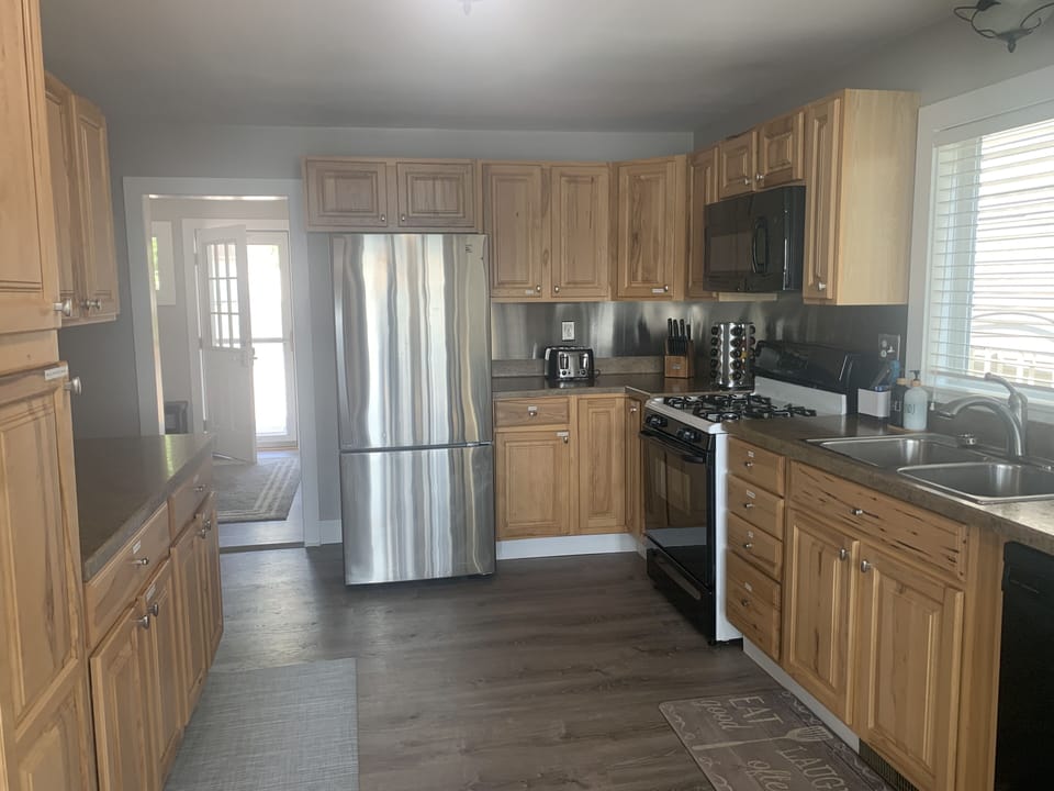 Updated kitchen with gas stove/oven, Dishwasher, and large refrigerator