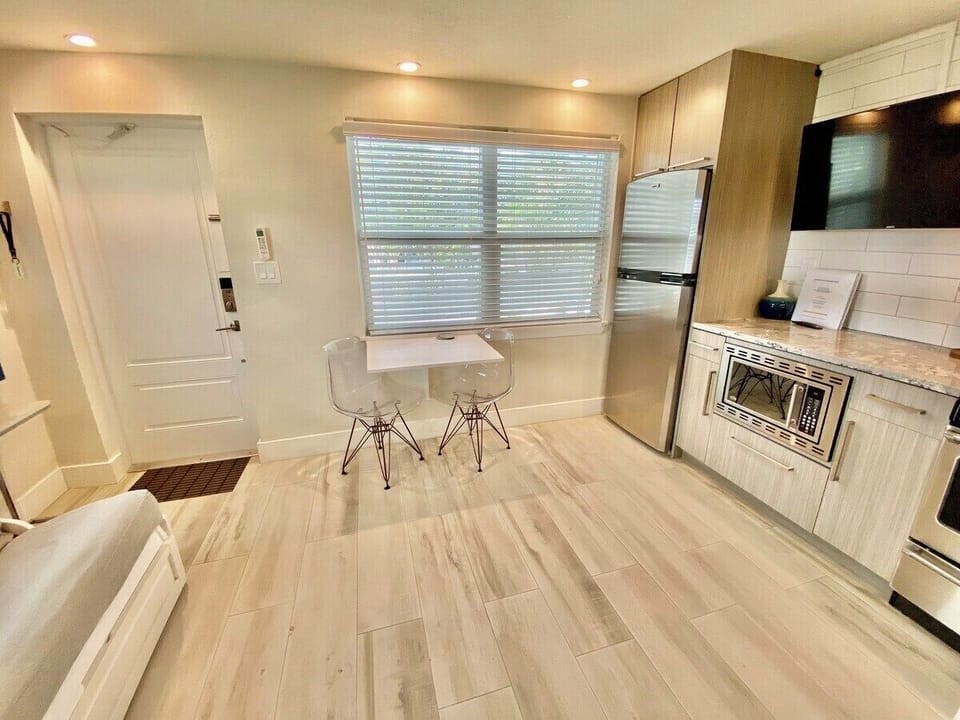 Stainless steel appliances, quartz countertops, and fully stocked kitchen with blender, pots, pans, etc.