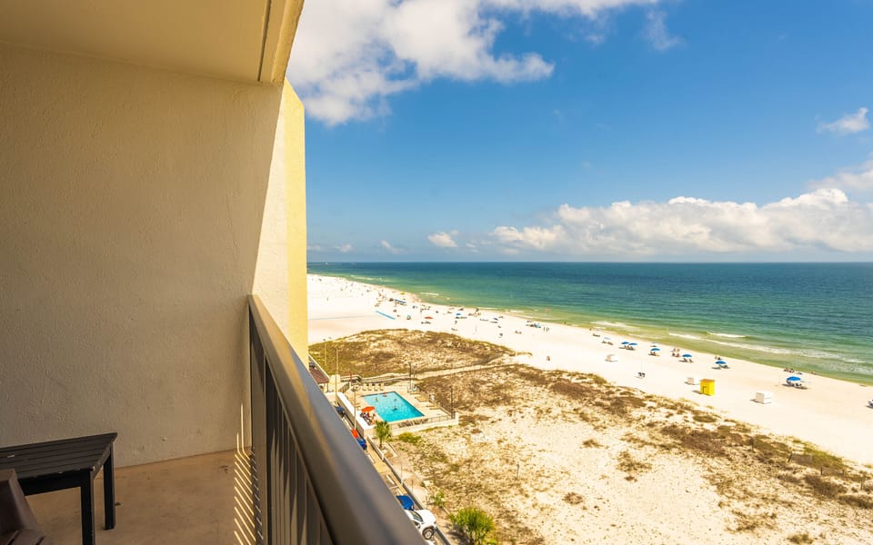 This balcony offers a stunning beach view with a cozy seating area, perfect for relaxation and enjoying the scenery