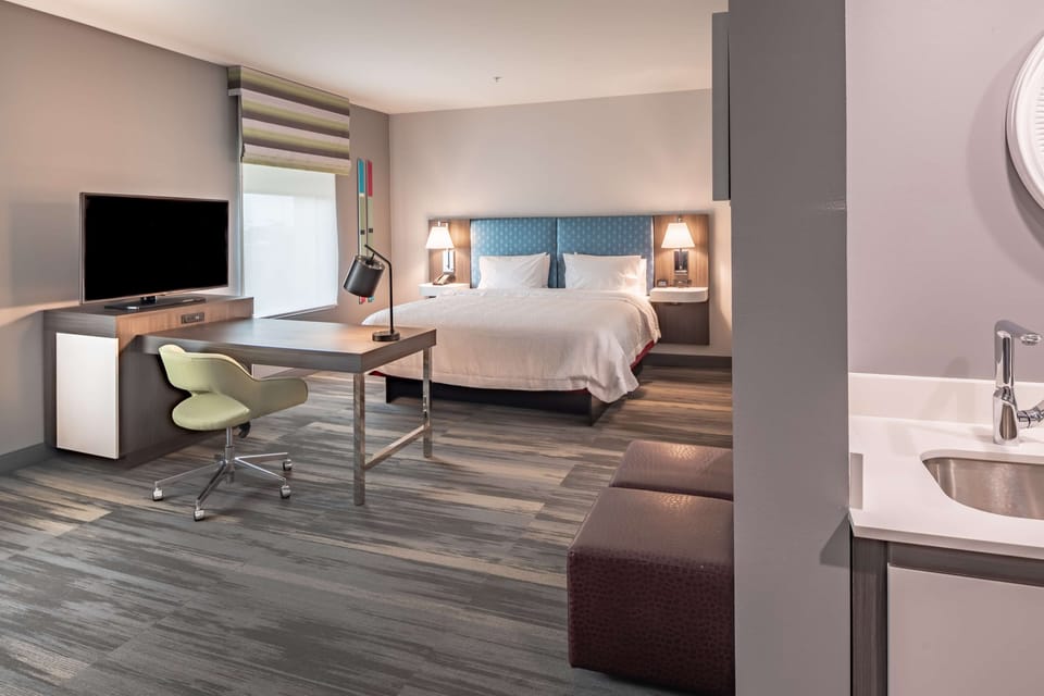 Suite, 1 King Bed, Accessible, Refrigerator & Microwave (Hearing) | Desk, laptop workspace, blackout drapes, iron/ironing board