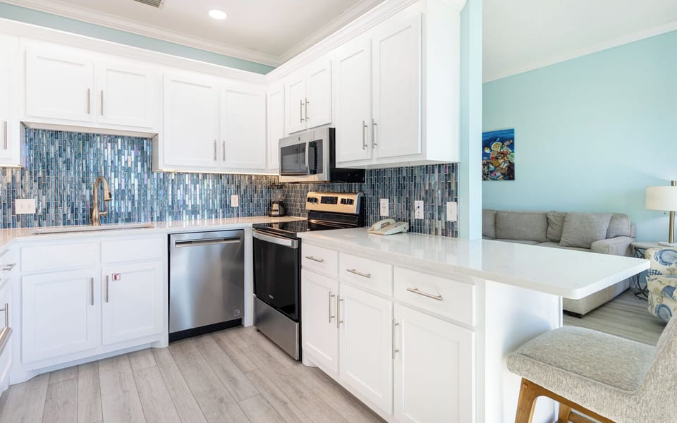 White cabinetry frames your kitchen's elegant design, so family dinners start with ease