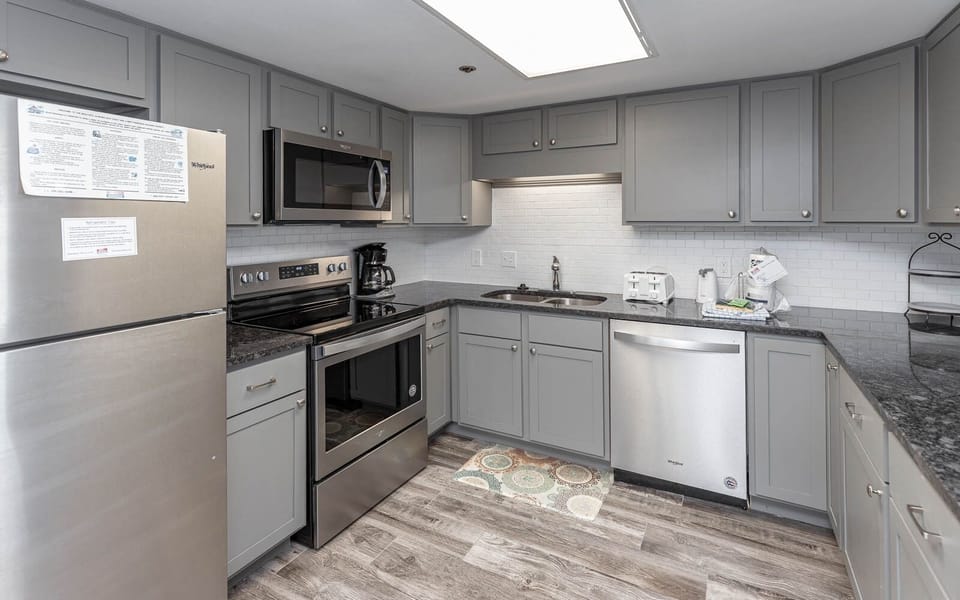 Prepare meals in this stylish kitchen featuring stainless appliances and ample counter space