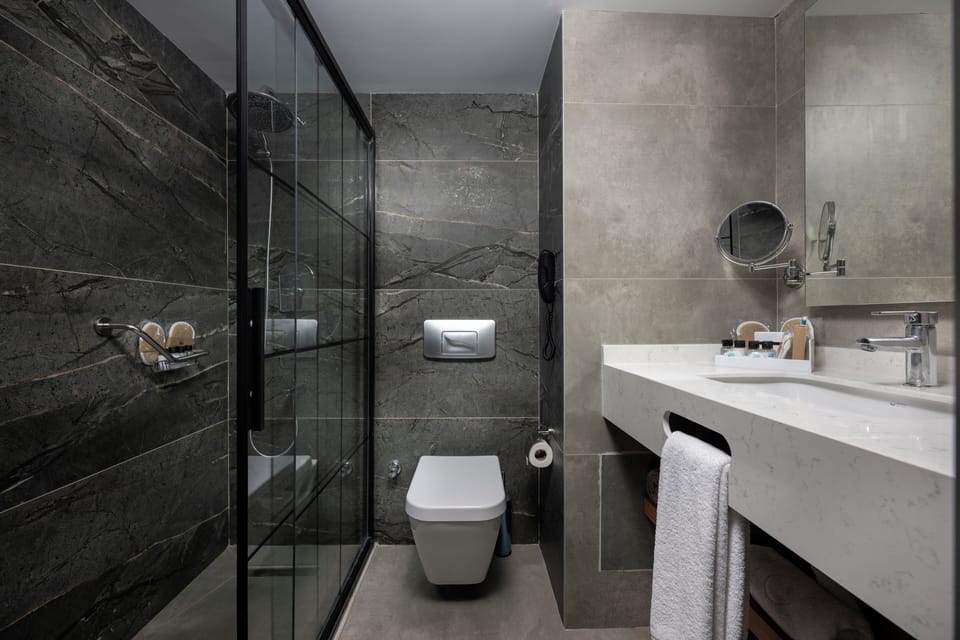 Suite, Sea View | Bathroom | Shower, free toiletries, hair dryer, slippers