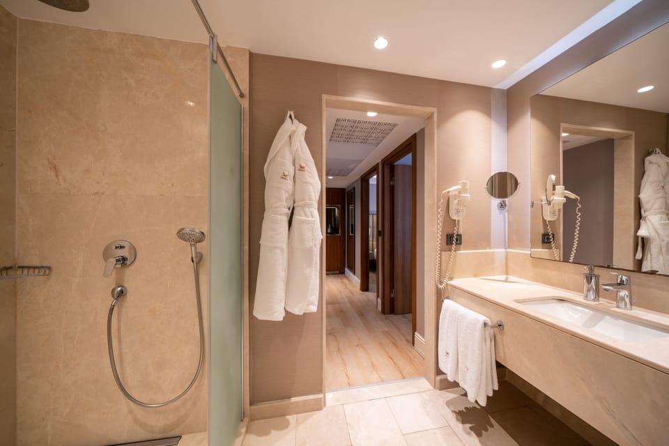 Deluxe Family Room Land Side | Bathroom | Shower, free toiletries, hair dryer, slippers
