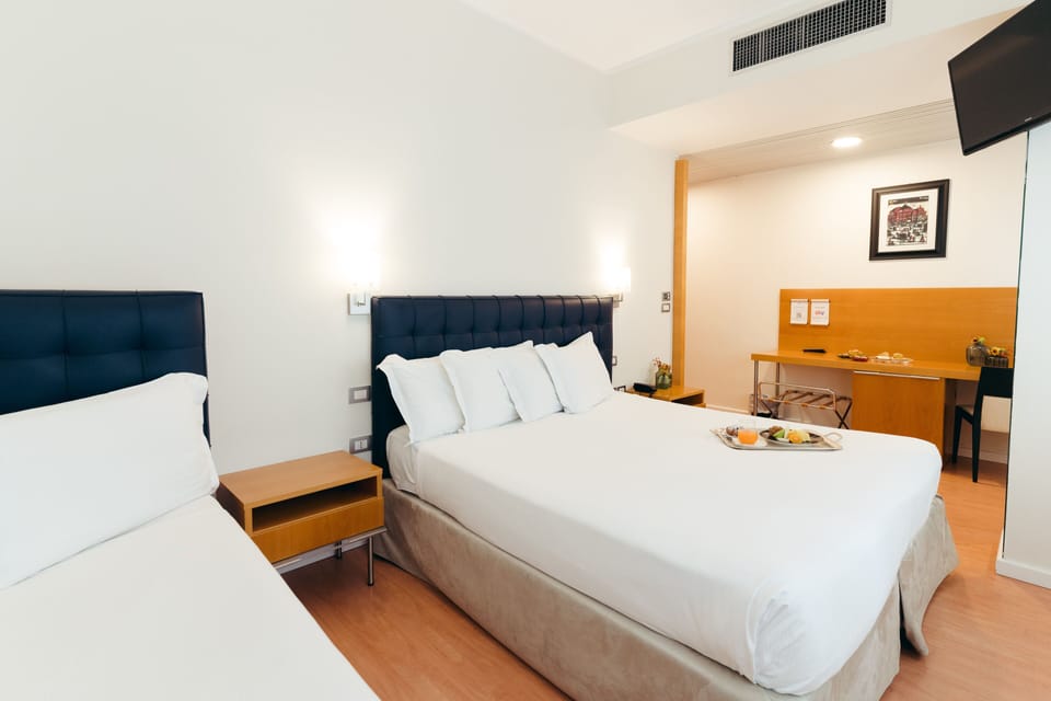 Triple Room | Minibar, in-room safe, desk, blackout drapes